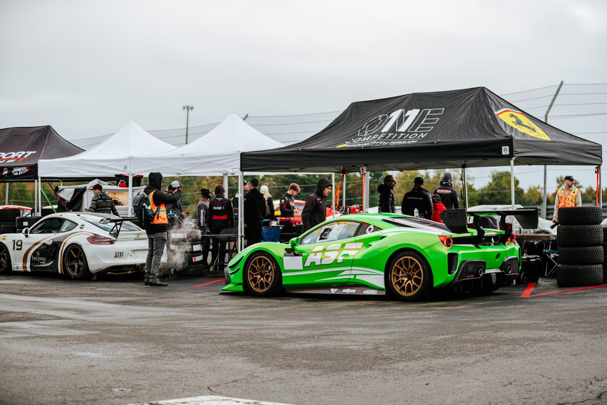 race cars are parked in pit lane before a race