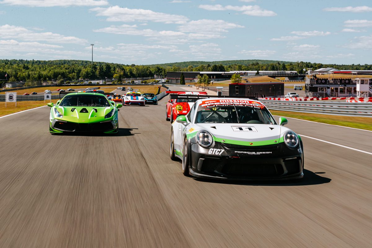 a group of race cars racing down the track