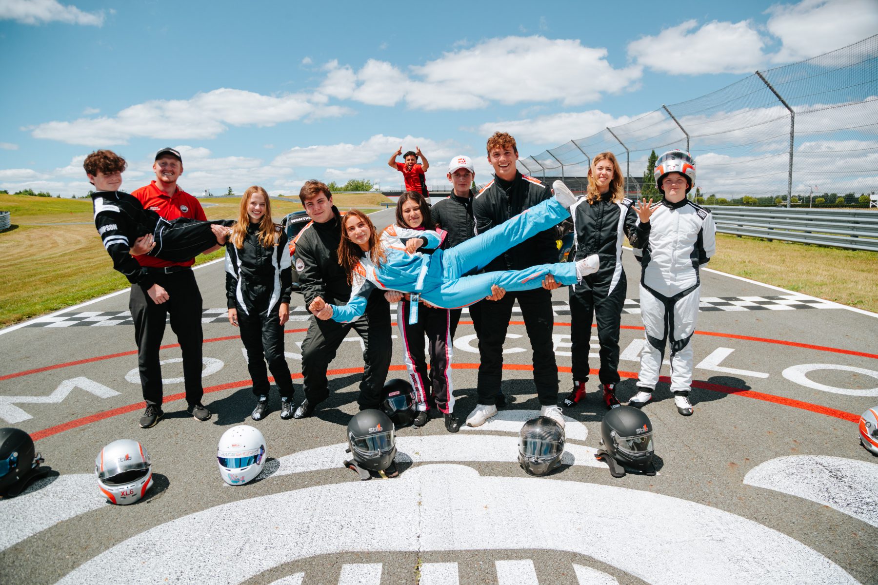 A group of teens posed on the start/finish line