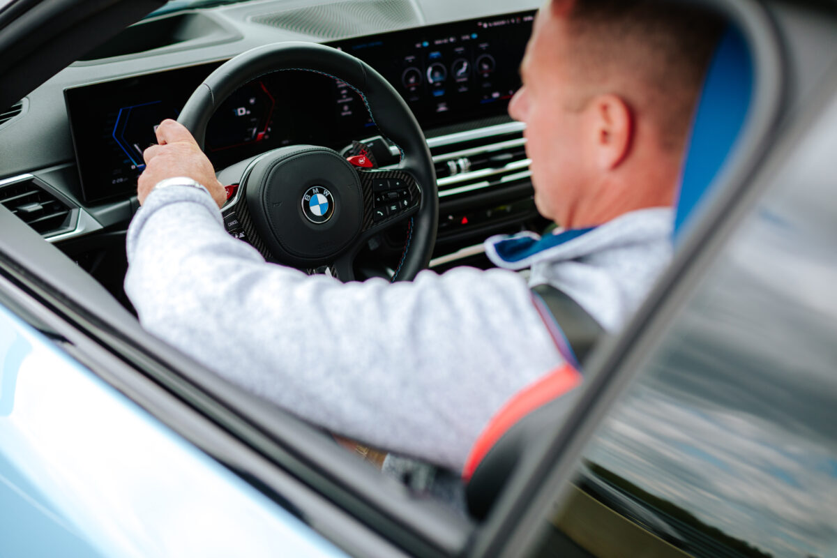 A male guest holding on to the BMW steering wheel