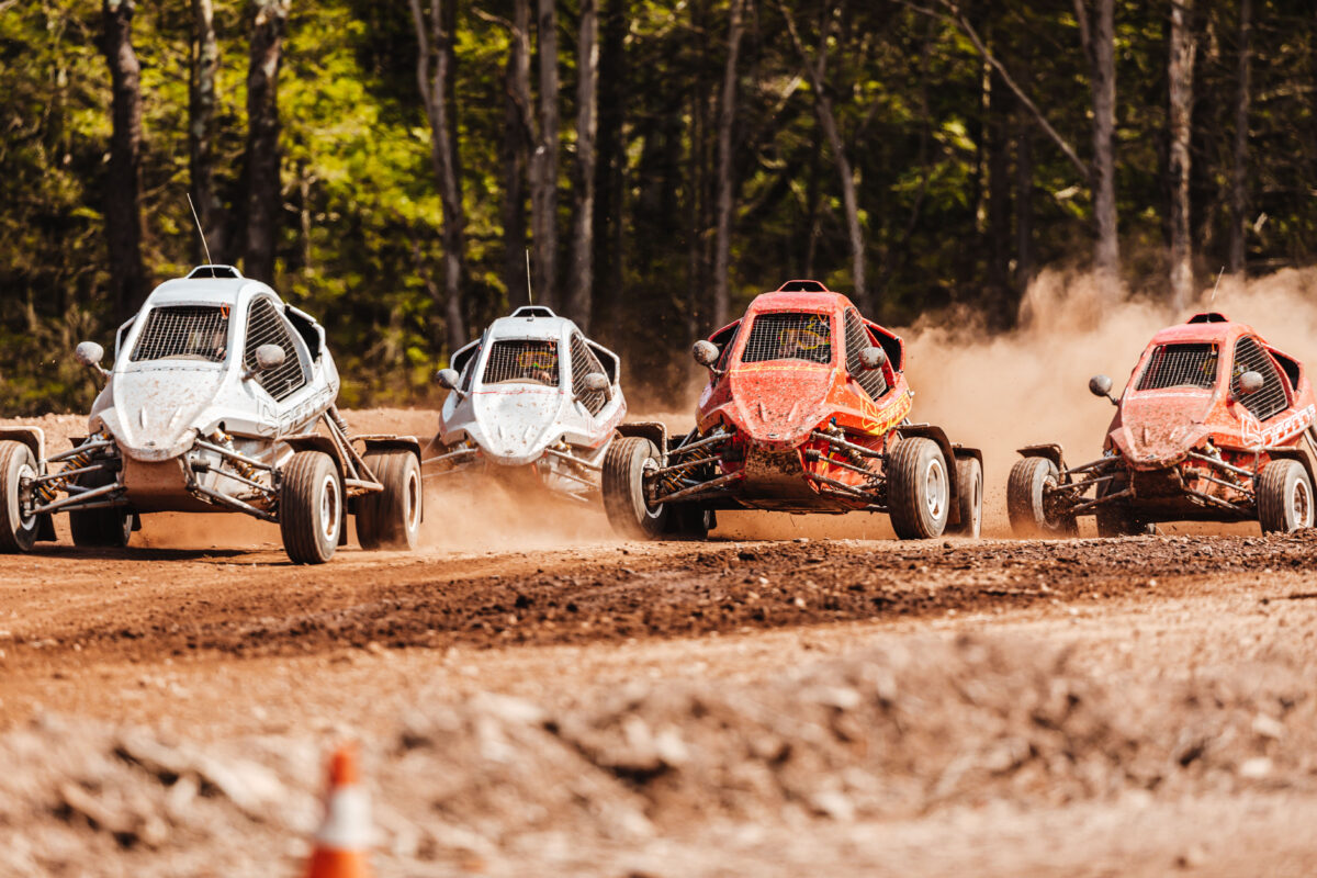 4 Cross karts racing through the dirt