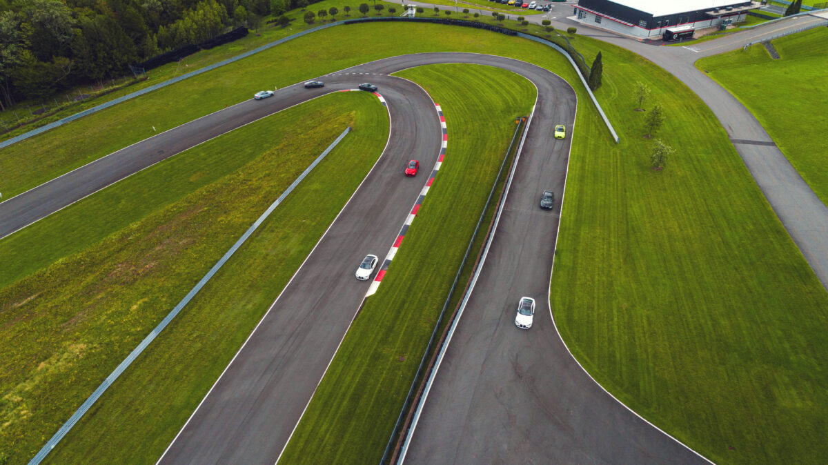 An aerial view of the track with cars racing around